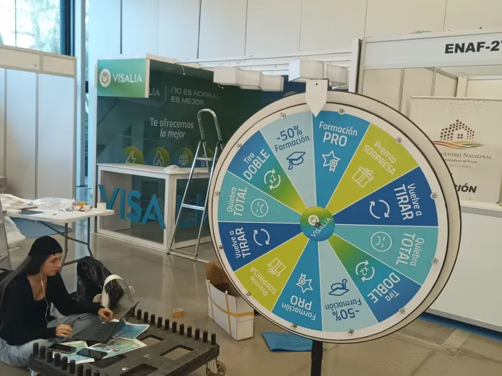 Setting up a promotional wheel in an exhibition hall