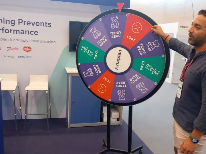 Visitor spinning a prize wheel at a trade show