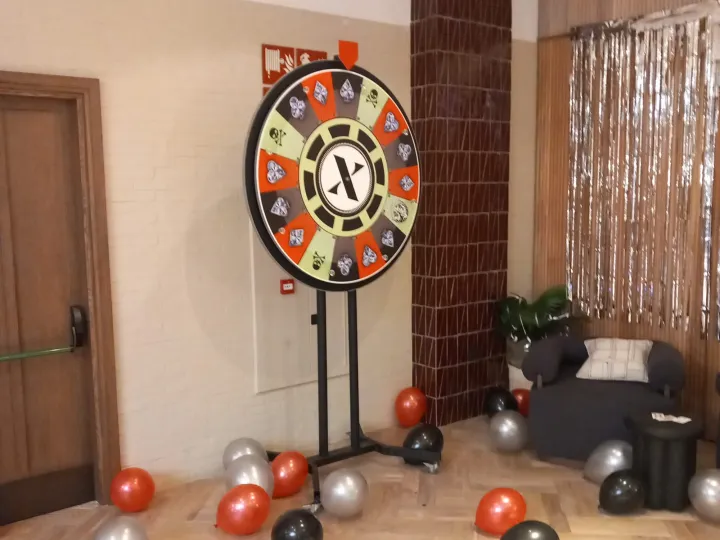 Party prize wheel with black and silver balloons
