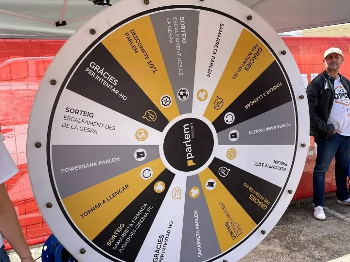 Yellow and grey giant prize wheel under a marquee