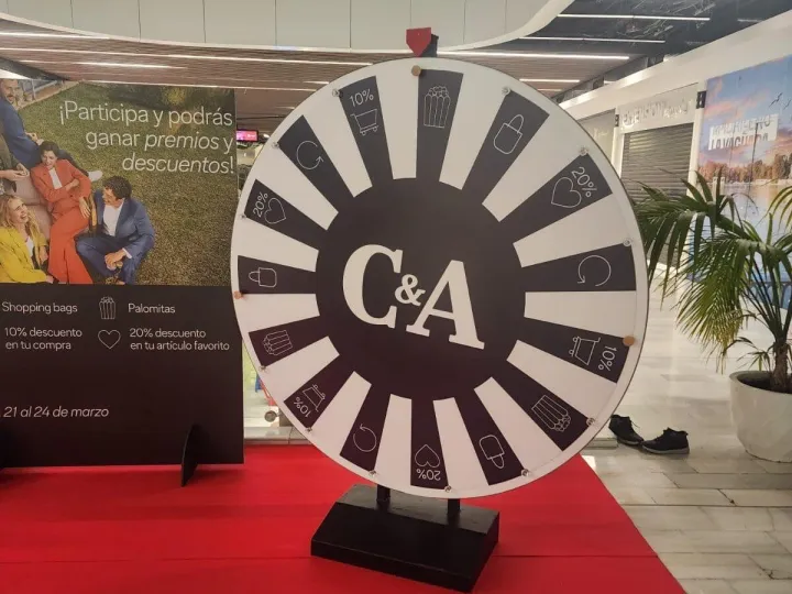 Black and white giant wheel on a red carpet in a shopping centre