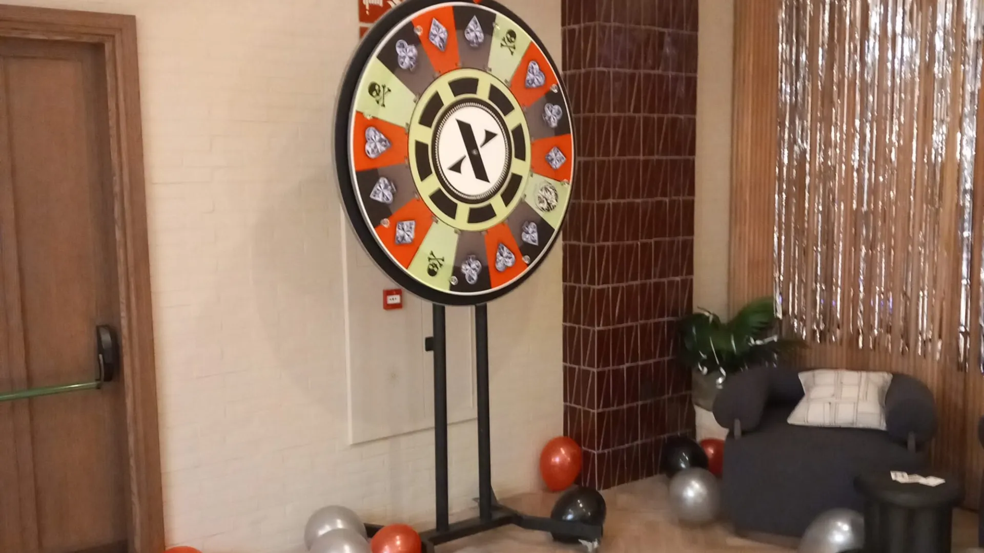 Party prize wheel with black and silver balloons