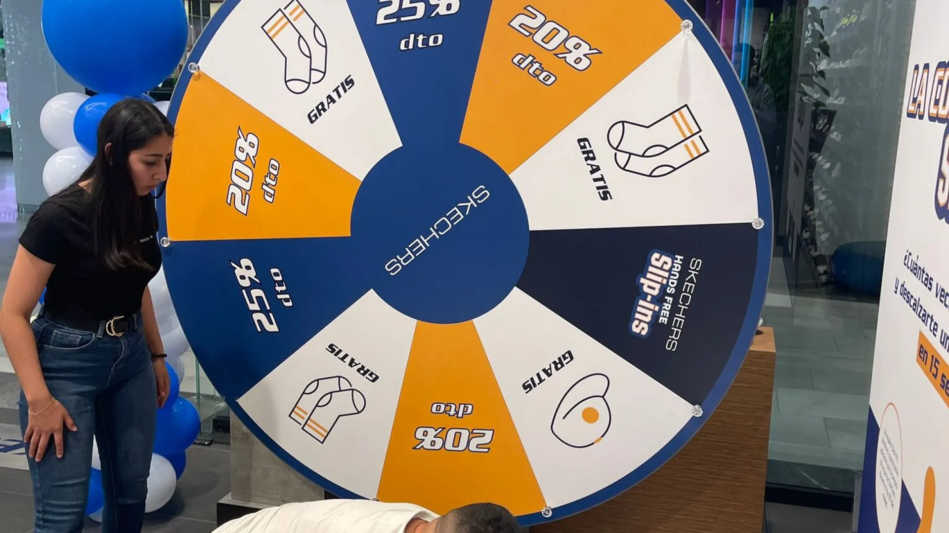Setting up a giant prize wheel in a shoe shop