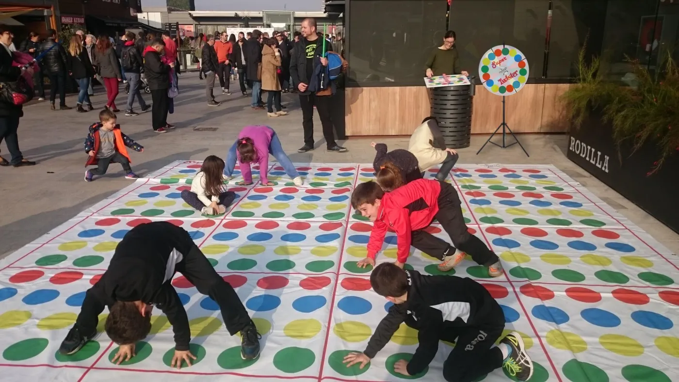 Children playing a giant floor game with a spinner at a shopping centre