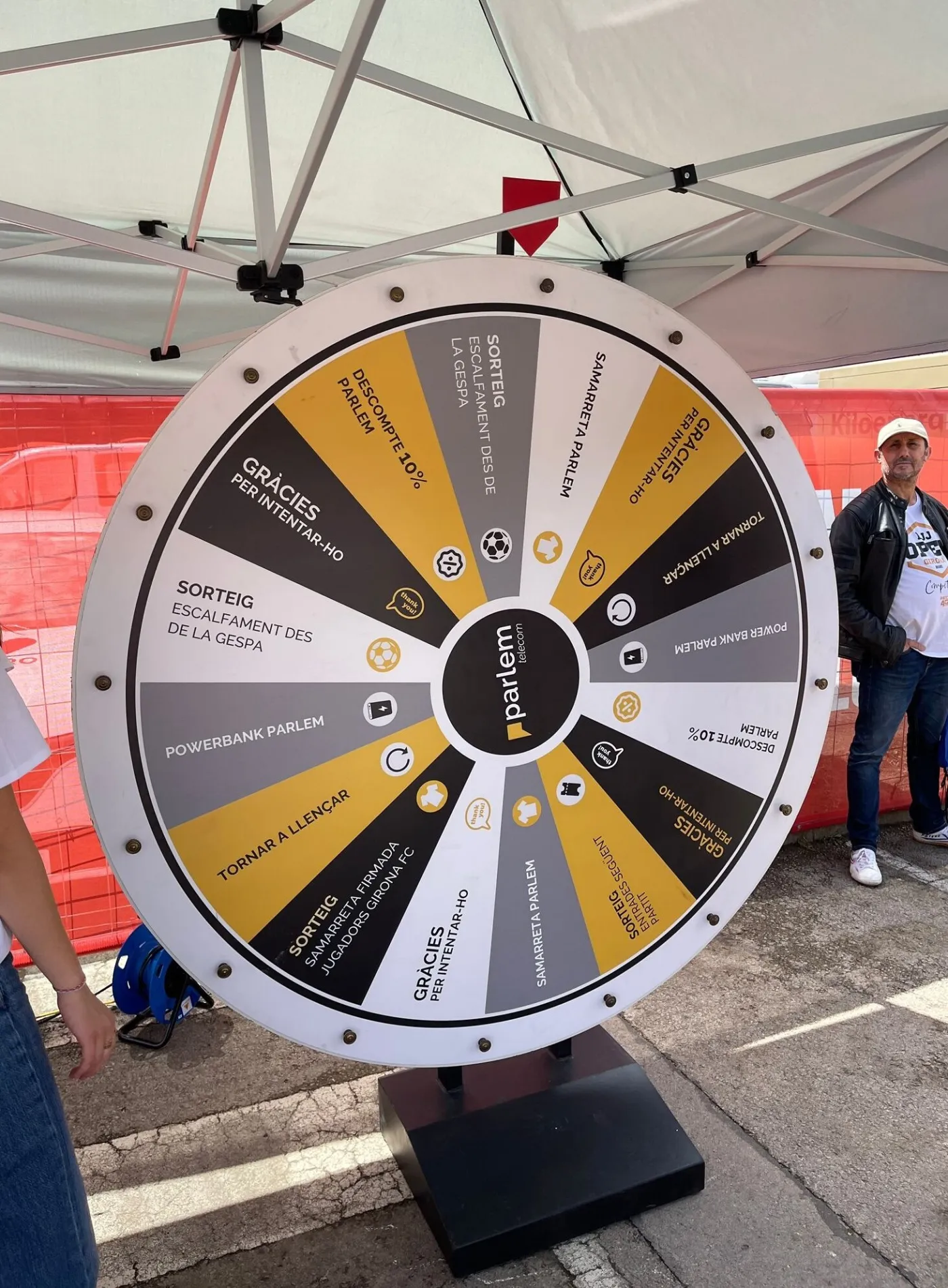Yellow and grey giant prize wheel under a marquee